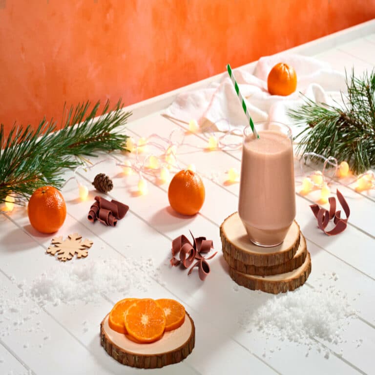 Des oranges, du chocolat et un shake F1 sur une table